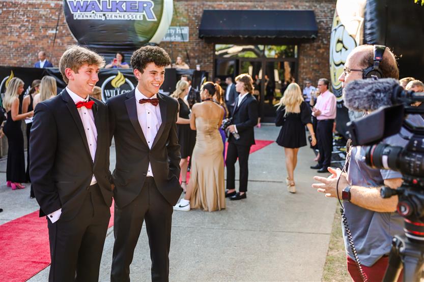Students walk down the red carpet